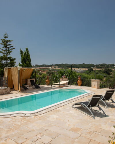 Trulli Retreat, Pool, Locorotondo: Swimming Pool, Composite Material, Outdoor Furniture, Flagstone, Shade, Resort, Chair, Estate, Hacienda, Water Feature