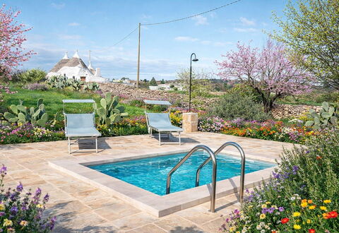 Trulli al Verde Viburno: Garden, Shrub, Swimming Pool, Landscaping, Flagstone, Backyard, Outdoor Furniture, Chair, Yard