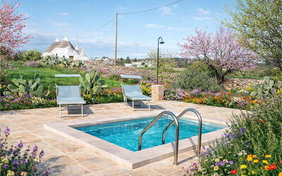 Trulli al Verde Viburno: Garden, Shrub, Swimming Pool, Landscaping, Flagstone, Backyard, Outdoor Furniture, Chair, Yard