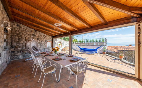 Villa Pietraluna: Flooring, Furniture, Floor, Chair, Flowerpot, Houseplant, Resort, Tile, Balcony, Wood Stain