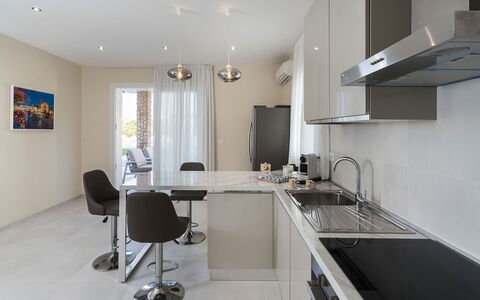 Villa Agorà: Furniture, Kitchen, Countertop, Interior Design, Flooring, Light Fixture, Cabinetry, Kitchen Appliance, Floor, Ceiling