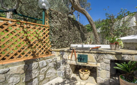 Villa Sea Breeze: Flagstone, Stone Wall, Garden, Outdoor Furniture, Flowerpot, Backyard, Houseplant, Landscaping, Shade, Patio