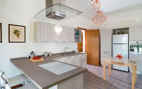 Salt Villa: Furniture, Kitchen, Countertop, Kitchen Appliance, Interior Design, Cabinetry, Flooring, Floor, Wood, Light Fixture