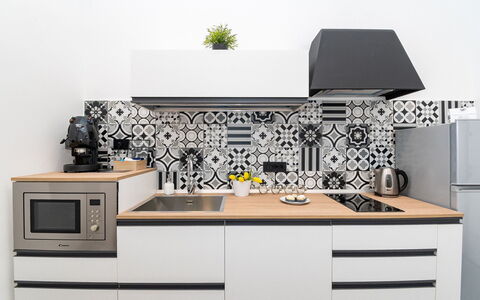 Apartment Vittoria: Kitchen, Countertop, Interior Design, Kitchen Appliance, Flooring, Cabinetry, Furniture, Floor, Room, Kitchen Stove
