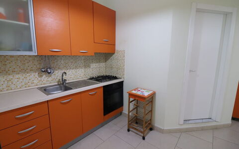 Lucia: Kitchen, Kitchen Appliance, Major Appliance, Countertop, Flooring, Wood, Kitchen Sink, Floor, Cabinetry, Interior Design