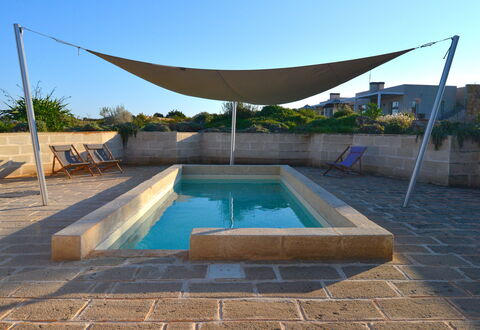 Villa Carovi: Swimming Pool, Composite Material, Shade, Flagstone, Concrete, Outdoor Furniture, Tile, Landscaping, Backyard, Courtyard