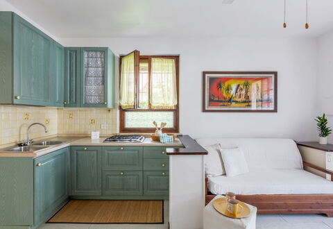 Veranda sul Conero: Furniture, Interior Design, Cabinetry, Flooring, Wood, Kitchen, Countertop, Floor, Kitchen Appliance, Room