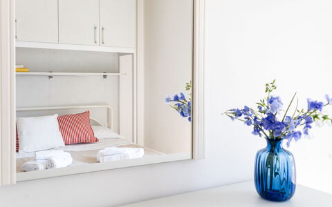 Suite Riviera: Furniture, Interior Design, Lighting, Room, Floor, Shelving, Shelf, Picture Frame, Throw Pillow, Pillow