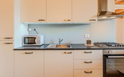 La Terza Casa: Kitchen, Countertop, Kitchen Appliance, Cabinetry, Major Appliance, Interior Design, Wood, Flooring, Kitchen Stove, Furniture