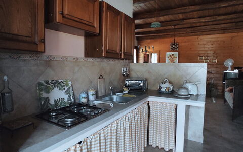 Baita Vignola: Kitchen, Flooring, Interior Design, Wood, Furniture, Floor, Countertop, Kitchen Appliance, Room, Kitchen Stove