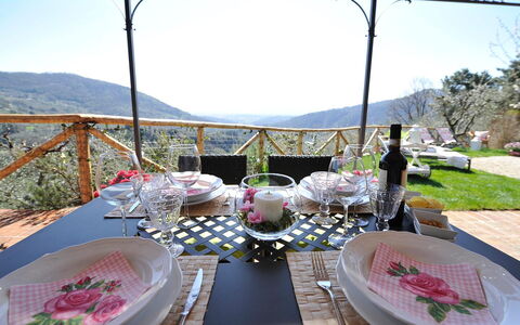 Oliveta: Furniture, Table, Tableware, Chair, Tablecloth, Hill, Outdoor Furniture, Drinkware, Serveware, Mountain Range