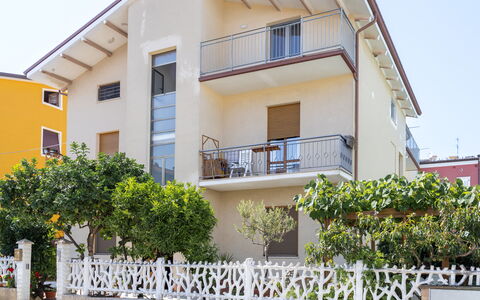 Seaside Apartment: Building, Residential Area, House, Facade, Home, Neighbourhood, Door, Balcony, Apartment, Porch