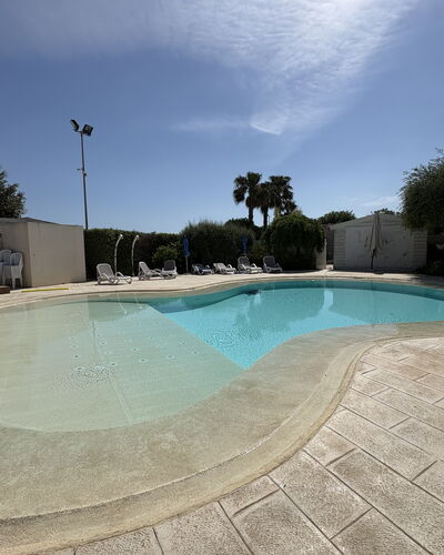 Villa Monaco: Swimming Pool, Composite Material, Concrete, Water Feature, Shade, Resort, Landscaping, Tile, Flagstone
