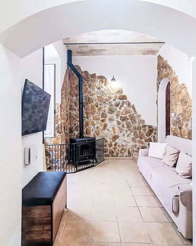 La Terrazza di Caramanico: Wall, Flooring, Interior Design, Floor, Ceiling, Room, Stone Wall, Living Room, Couch