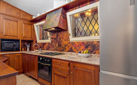 Villa Stella 6: Kitchen, Wood, Countertop, Cabinetry, Major Appliance, Interior Design, Flooring, Kitchen Appliance, Lighting, Brown