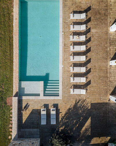 Opuntia Trulli e Lamie 10: Swimming Pool, Composite Material, Resort, Concrete, Outdoor Furniture, Design, Shade, Tile, Chair, Sunlounger