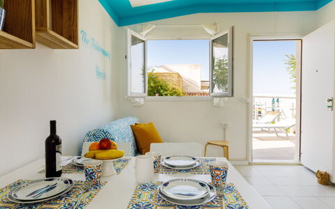 Casetta del Pescatore 4: Furniture, Interior Design, Home, Chair, Apartment, Wood Stain, Kitchen & Dining Room Table, Houseplant, Paint, Balcony