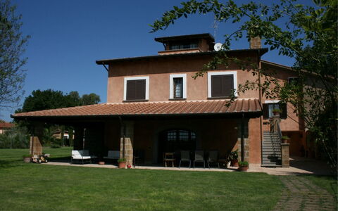 Villa Iris: Sky, Plant, Building, Property, Window, Tree, House, Shade, Grass, Siding
