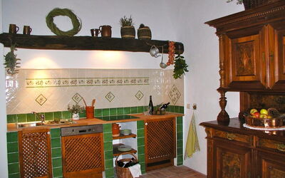 Kitchen with electric stove and dishwasher and living area