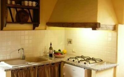 Apt Il Melograno: Property, Room, Kitchen, Countertop, Furniture, Cabinetry, Building, Kitchen Stove, Interior Design, House